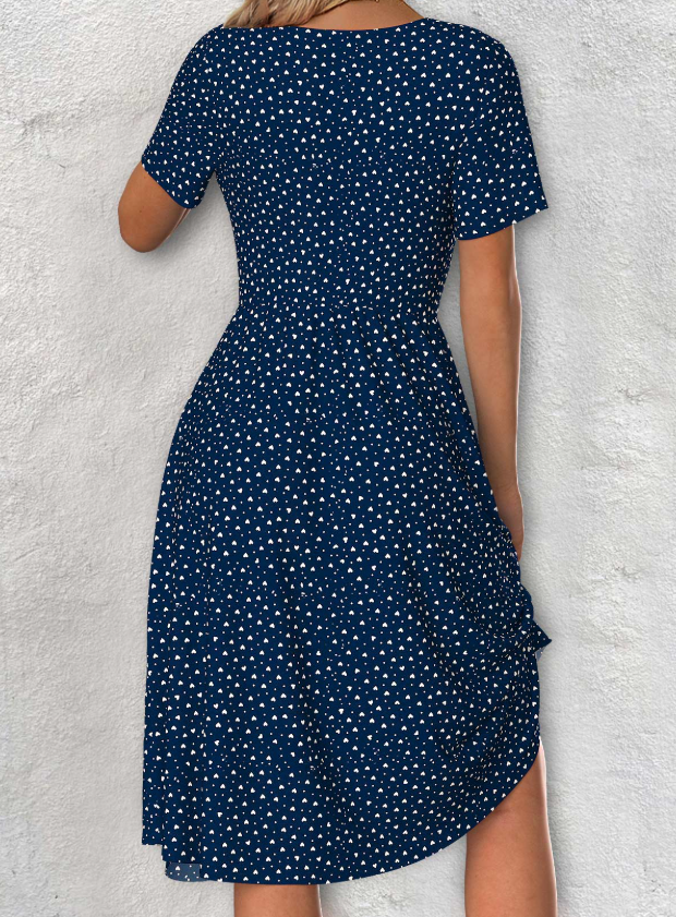Navy blue dress with short sleeves, V-neck, and polka dot pattern