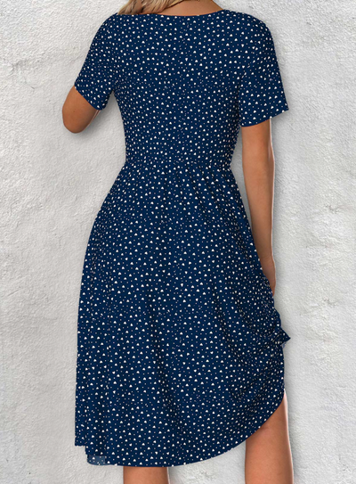Navy blue dress with short sleeves, V-neck, and polka dot pattern
